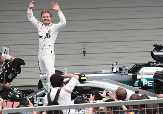 Mercedes AMG Petronas F1 Team's German driver Nico Rosberg waves whilst standing in his car after winning the Formula One Japanese Grand Prix race in Suzuka on October 7, 2016. / AFP PHOTO / BEHROUZ MEHRIBEHROUZ MEHRI/AFP/Getty Images
