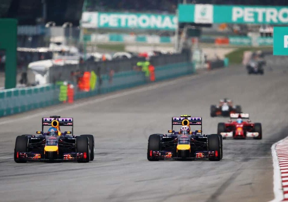KUALA LUMPUR, MALAYSIA - MARCH 30:  Sebastian Vettel of Germany and Infiniti Red Bull Racing and Daniel Ricciardo of Australia and Infiniti Red Bull Racing race during the Malaysia Formula One Grand Prix at the Sepang Circuit on March 30, 2014 in Kuala Lumpur, Malaysia.  (Photo by Paul Gilham/Getty Images) *** Local Caption *** Sebastian Vettel; Daniel Ricciardo